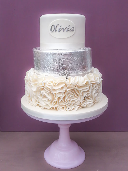 Silver leaf and scroll icing cake in three tiers.