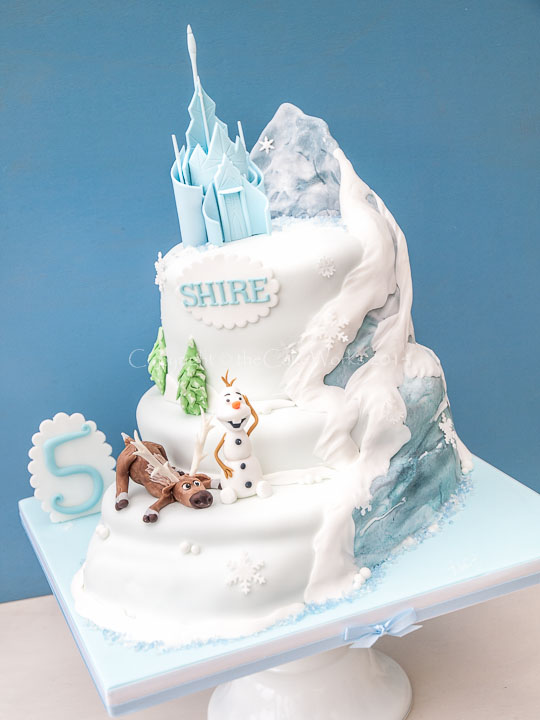 5th birthday cake based on Disney's Frozen film theme with Olaf and Sven on the mountain.